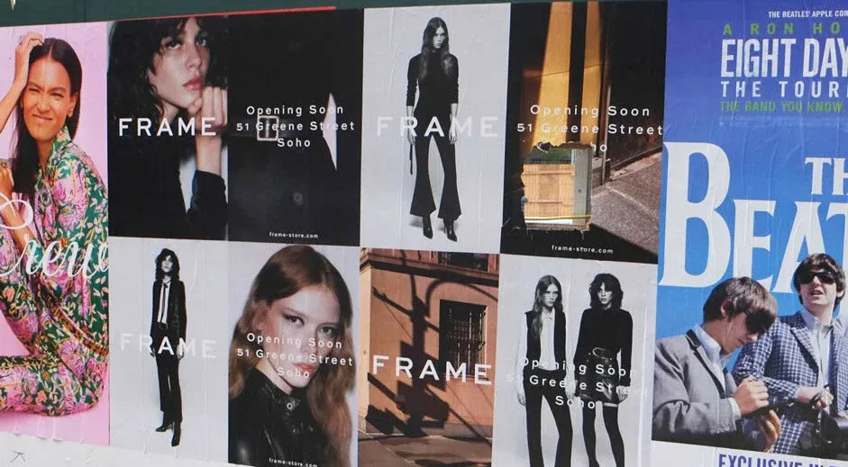 Grid of FRAME wild-posting posters wheatpasted along Greene Street in SoHo, New York.