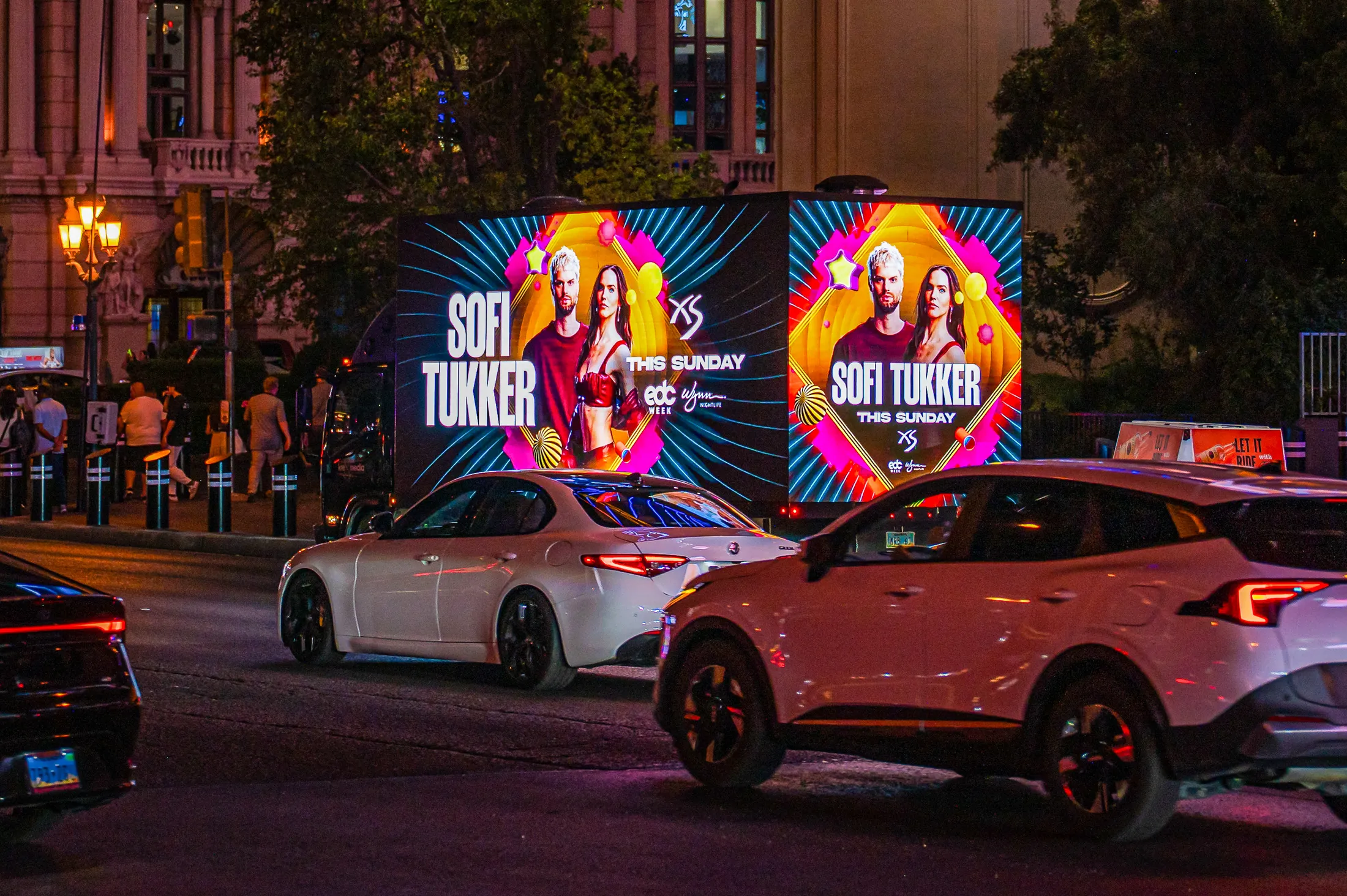 XS Nightclub Sofi Tukker creative on an LED billboard truck on Las Vegas Boulevard at night.