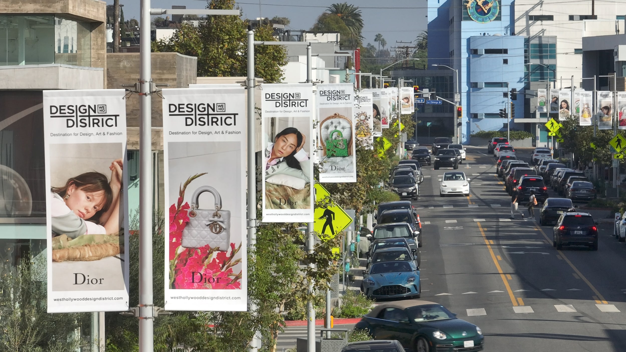 Dior pole banners lining a city street corridor.