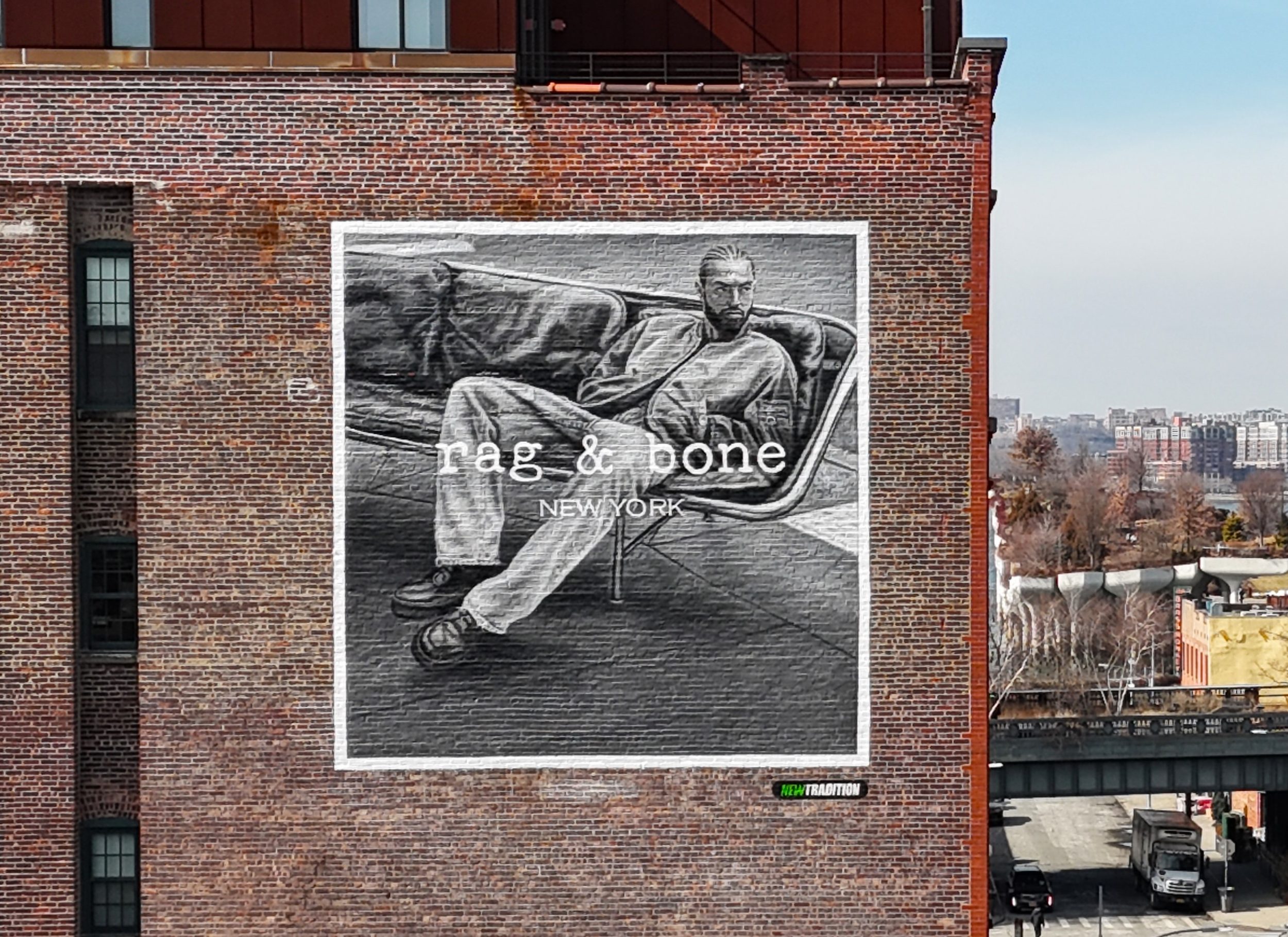 Rag & Bone hand-painted mural on a brick facade.